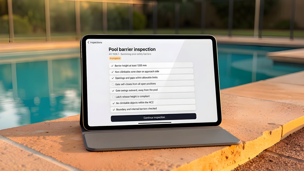 A pool compliance checklist displayed on a tablet beside a swimming pool